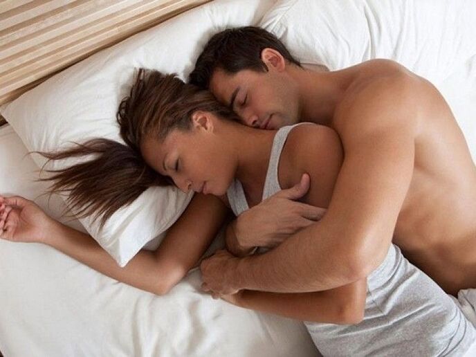 a woman in bed with a man who strengthens potency